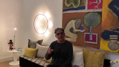 deepak sitting on a couch talking 